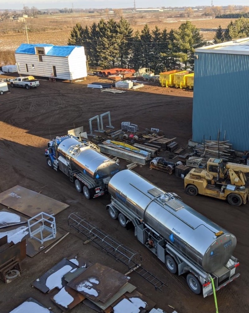 Two emergency tanker trucks at an industrial property