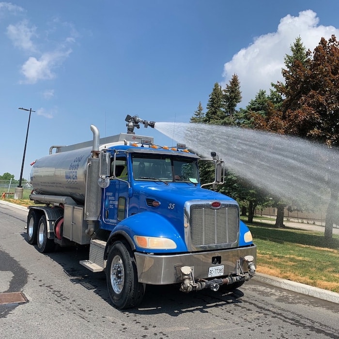 Water truck applying irrigation for sod and landscape watering